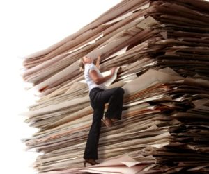 Business Woman Climbing a Pile of Files